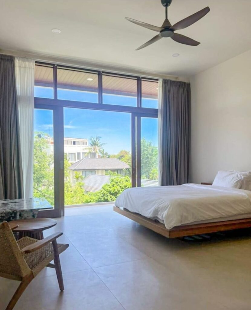 Upstairs bedroom and balcony above the palms